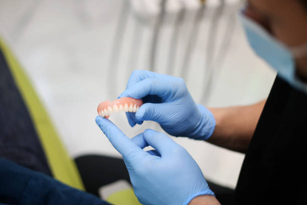 dentist holding dentures